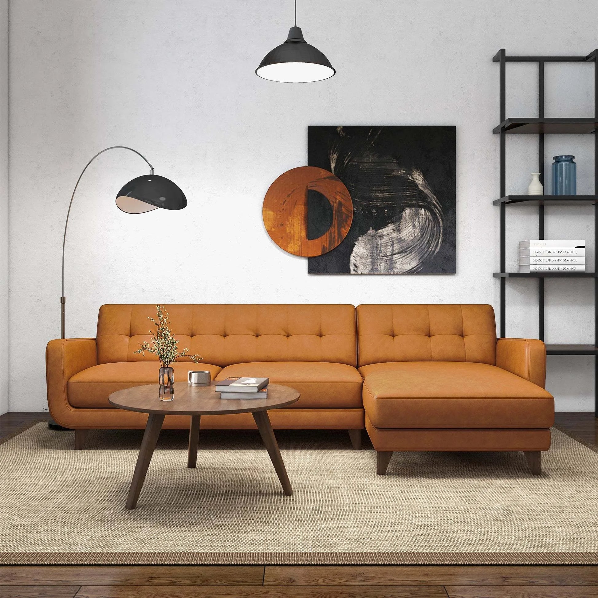 Modern living room with tan sectional sofa, round coffee table, abstract art, and shelving