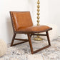 Modern brown leather accent chair with wood frame on patterned rug, FredCo furniture