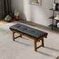 Modern wooden bench with black tufted cushion in stylish living room, FredCo International furniture