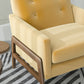 Modern yellow armchair with wooden frame on striped rug, FredCo International furniture