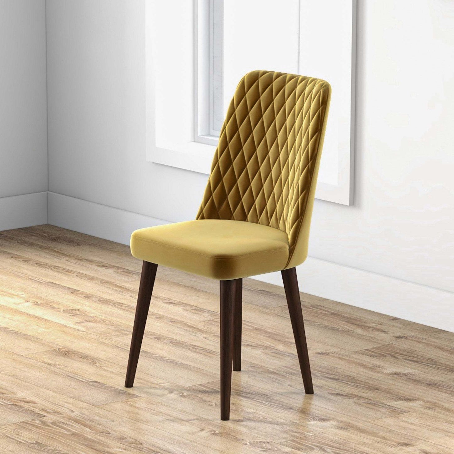 Modern mustard yellow velvet dining chair with quilted back and dark wood legs in bright room
