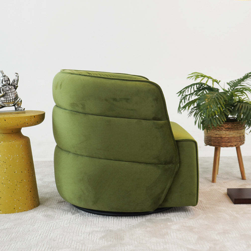 Modern green accent chair with velvet upholstery, yellow side table, potted plant, contemporary home furniture.