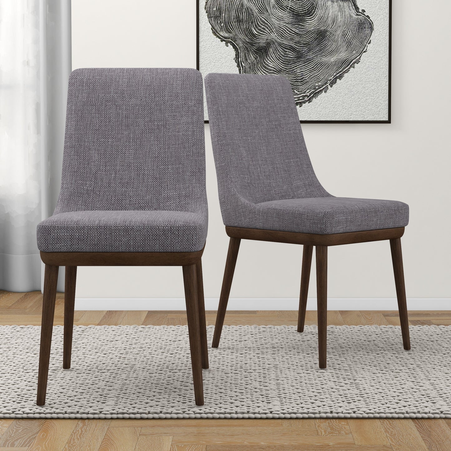 Set of two modern gray upholstered dining chairs with wooden legs on a rug in a stylish room