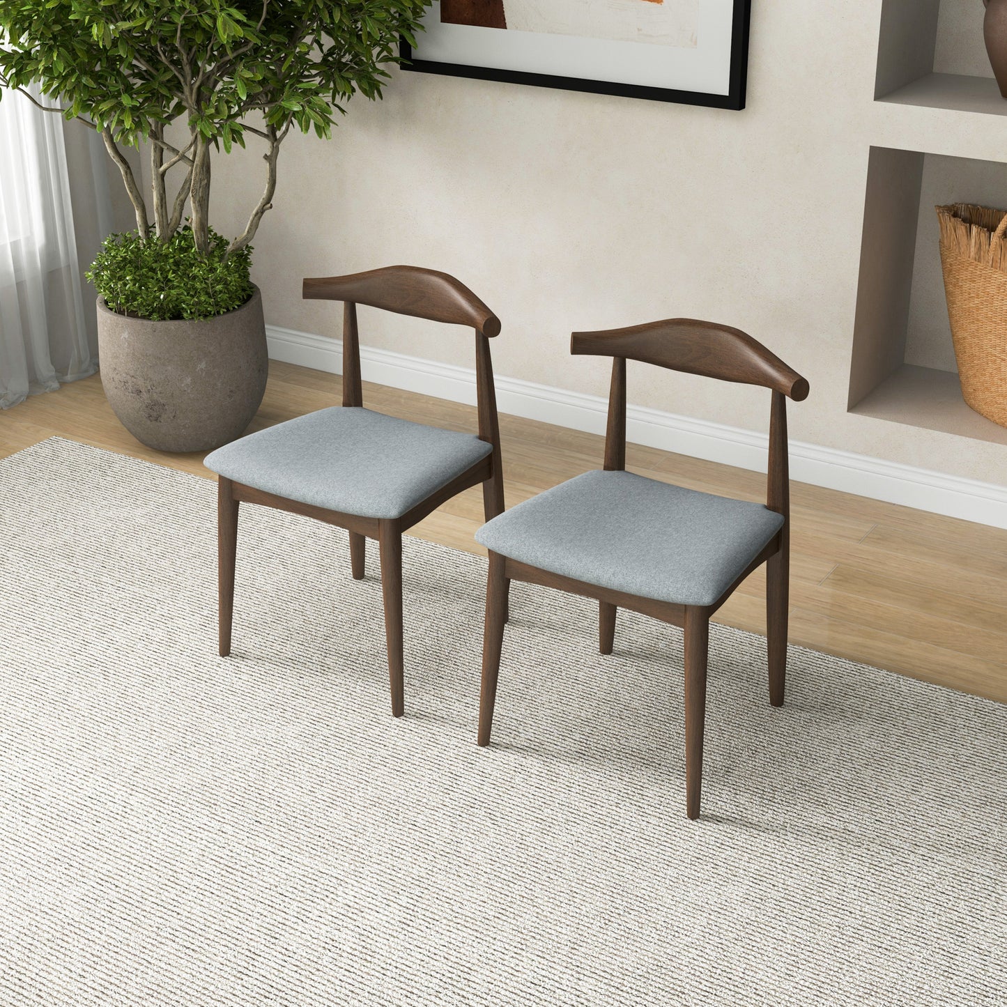 Pair of modern wood dining chairs with gray cushions in a bright living room, FredCo furniture