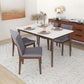 Modern dining room set with gray chairs, wood table, sideboard, and neutral decor from FredCo International.