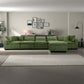 Modern living room with green sectional sofa, wall art, and neutral area rug, FredCo furniture
