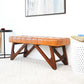 Modern tan leather bench with wood legs in a bright, contemporary living room setting.