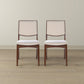 Pair of modern wood dining chairs with beige fabric seats on hardwood floor, FredCo International