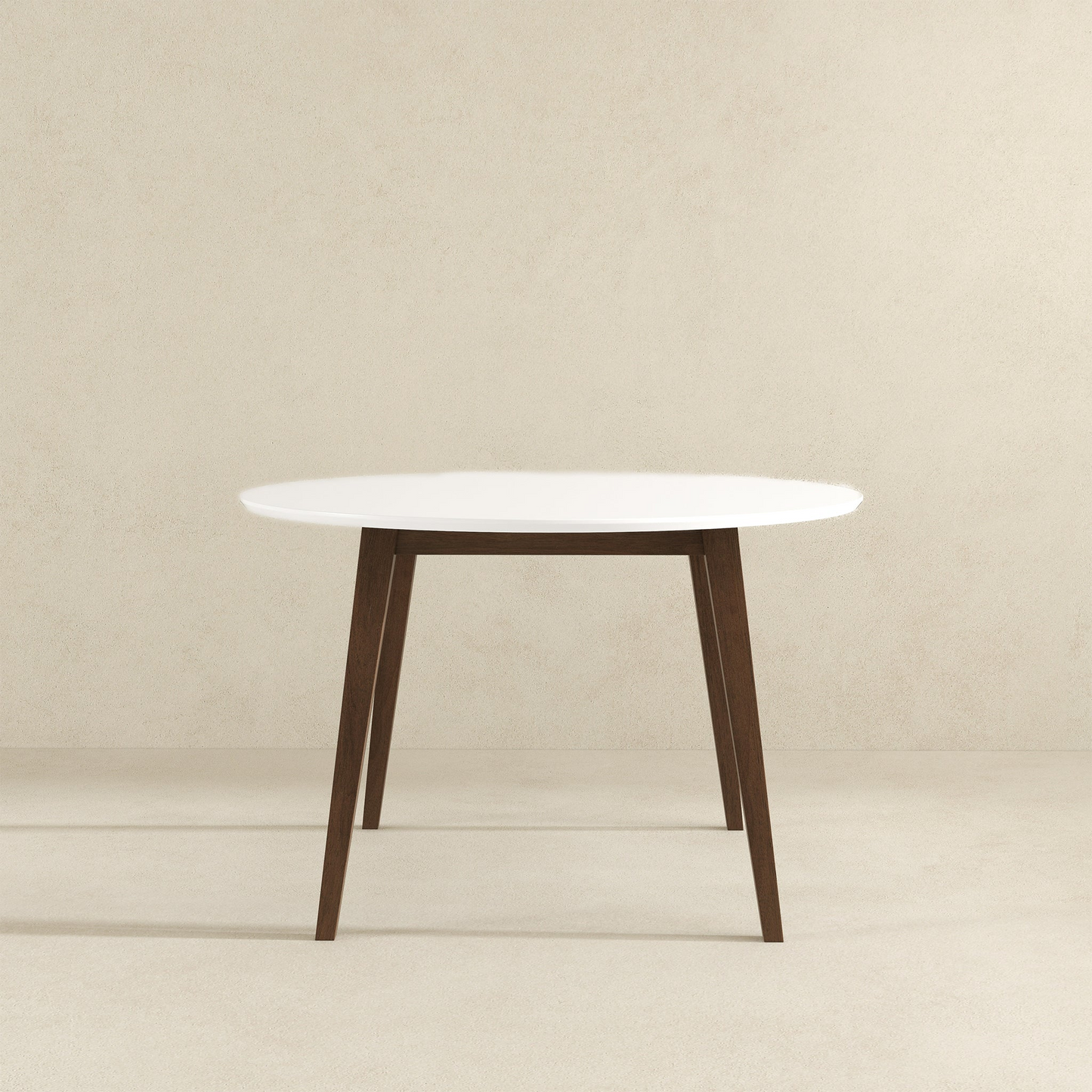Modern round dining table with white top and dark wood legs, minimalist home furniture