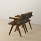 Pair of modern wooden chairs with black cushions on light wood floor, FredCo International furniture