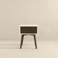 Mid-century modern wooden nightstand with white frame and single drawer on light background