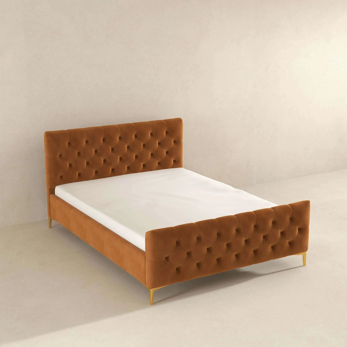 Modern tufted velvet bed frame with gold legs in minimalist bedroom setting