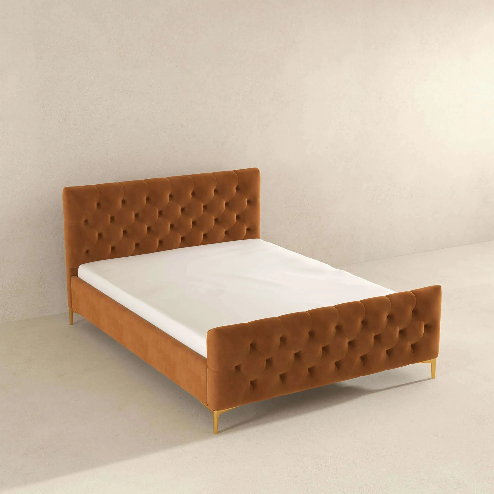 Modern tufted velvet bed frame with gold legs in minimalist bedroom setting