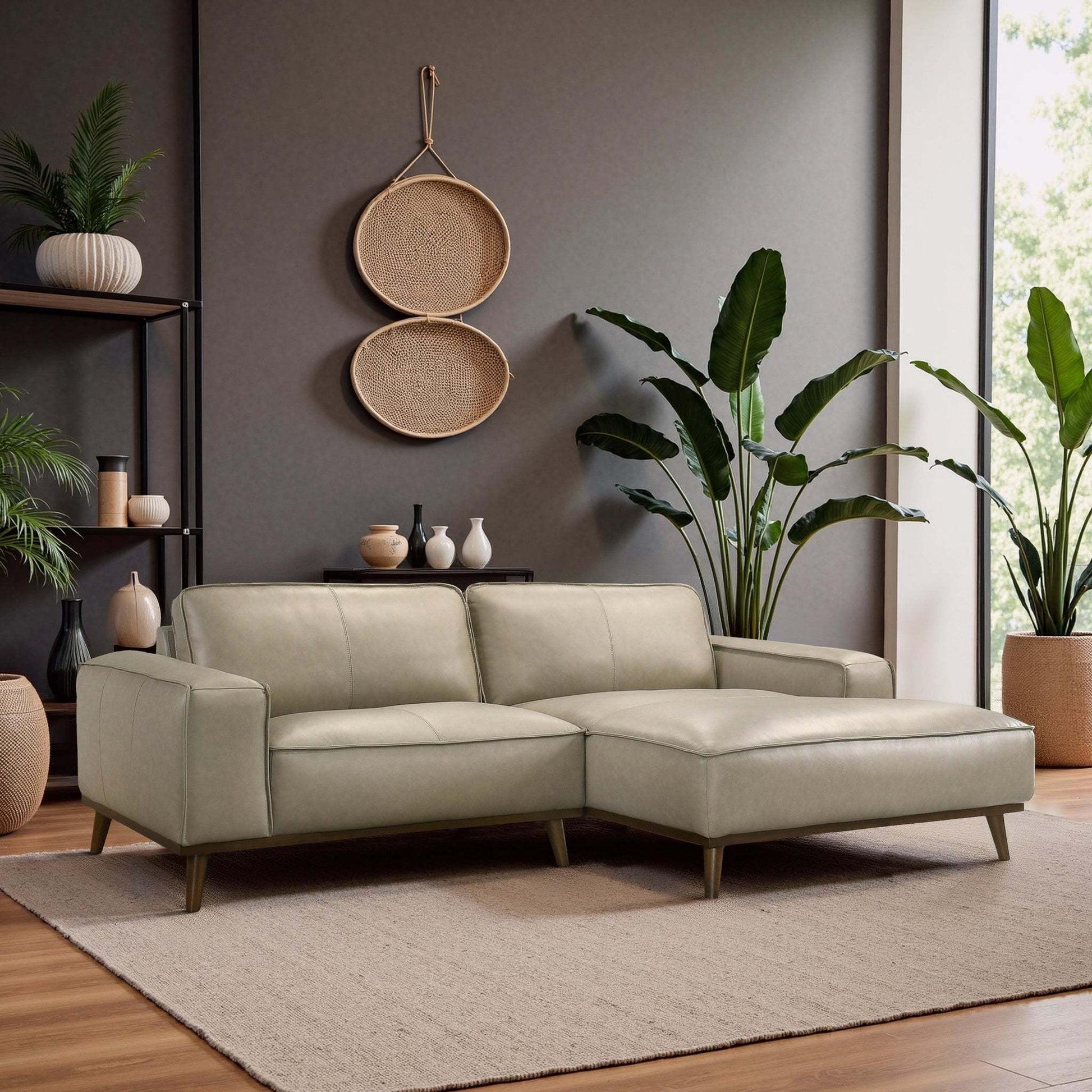 Modern living room with light gray sectional sofa, indoor plants, and neutral decor from FredCo International
