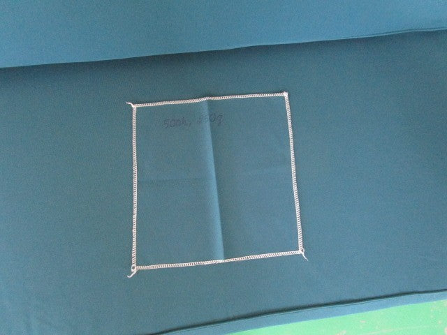 Teal fabric sample with stitched square swatch, FredCo International furniture upholstery.