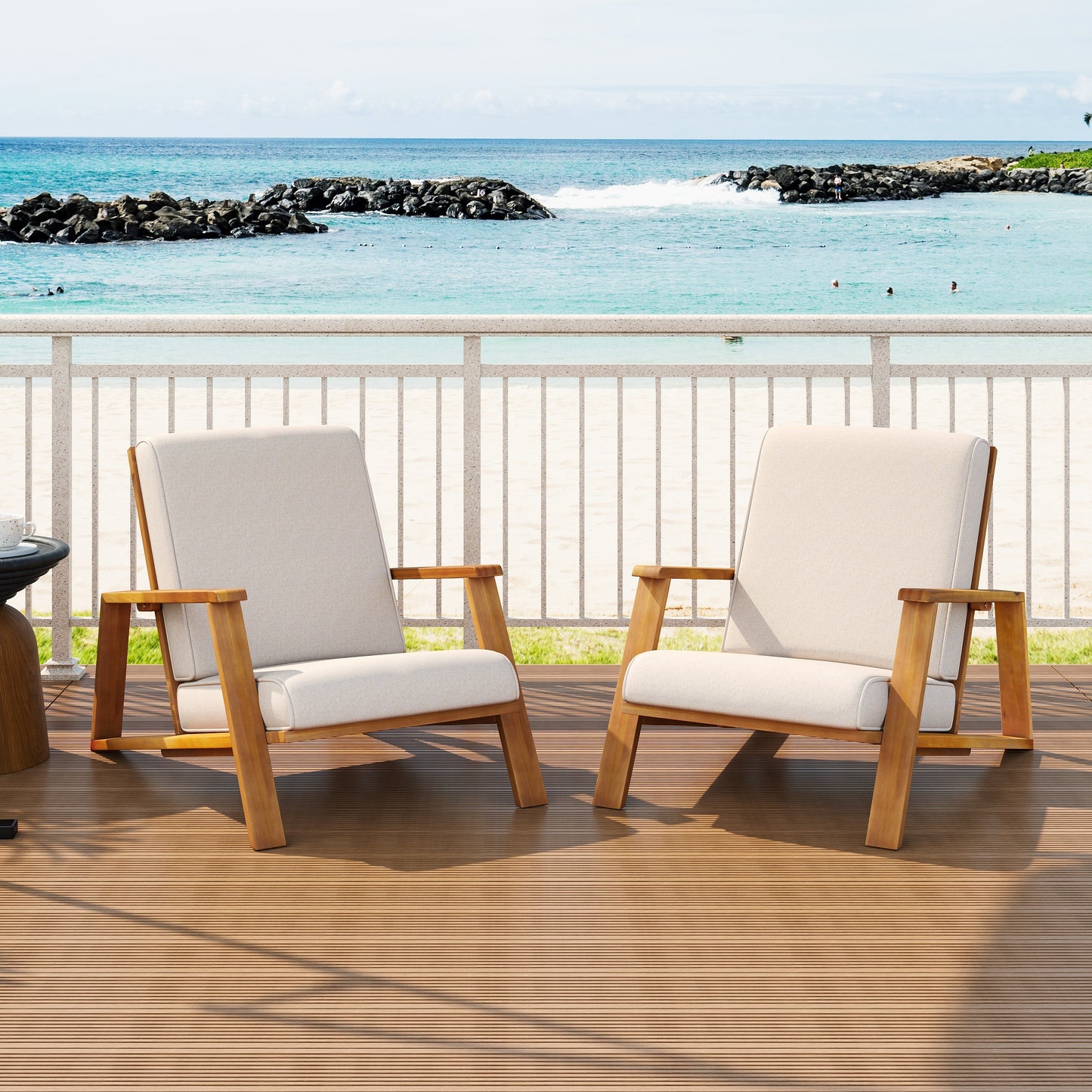 Outdoor patio chairs with wooden frames and beige cushions on a deck by the ocean