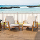 Outdoor patio chairs with wooden frames and beige cushions on a deck by the ocean