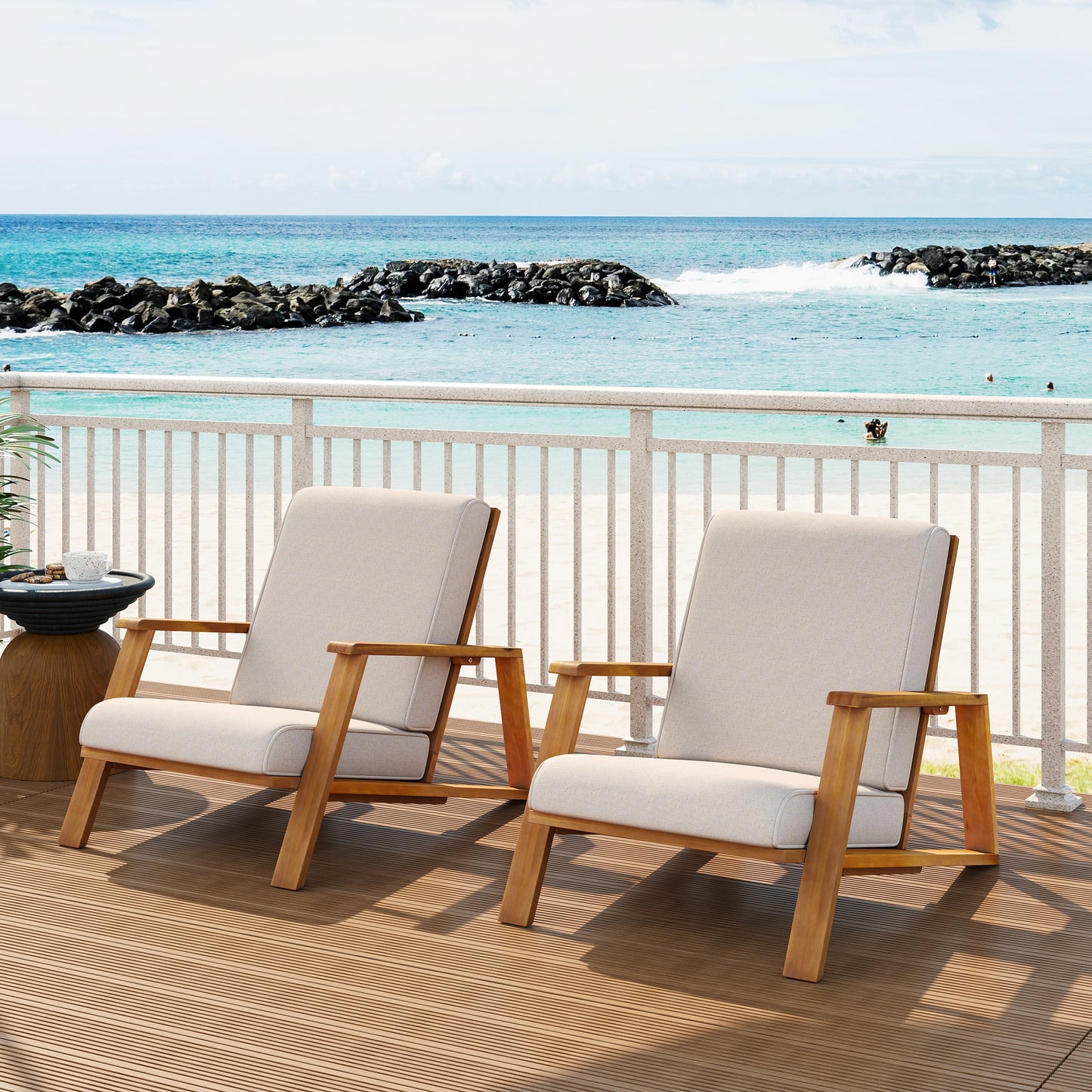 Modern wooden outdoor lounge chairs on a deck overlooking the ocean, FredCo International furniture