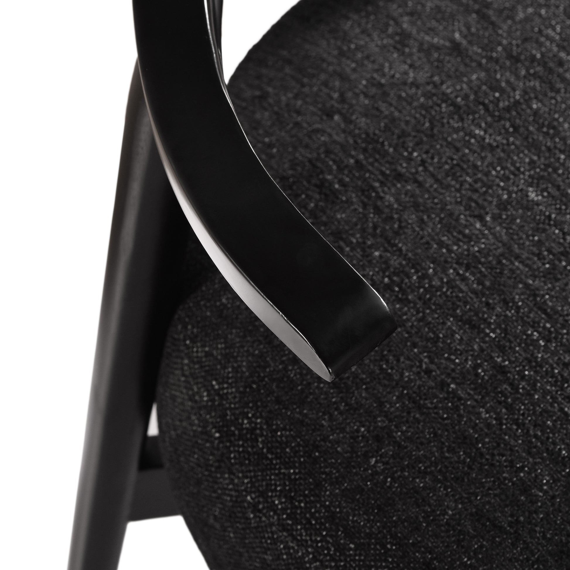 Close-up of modern black upholstered chair arm and seat from FredCo International furniture