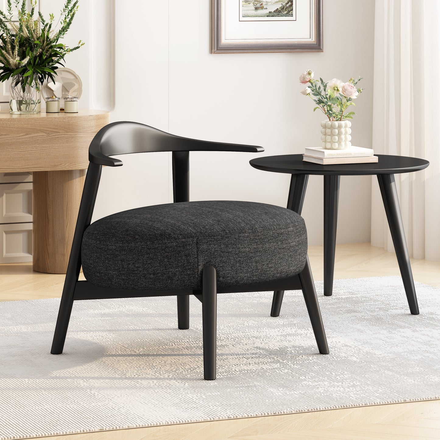 Modern black accent chair with round seat and matching side table in stylish living room